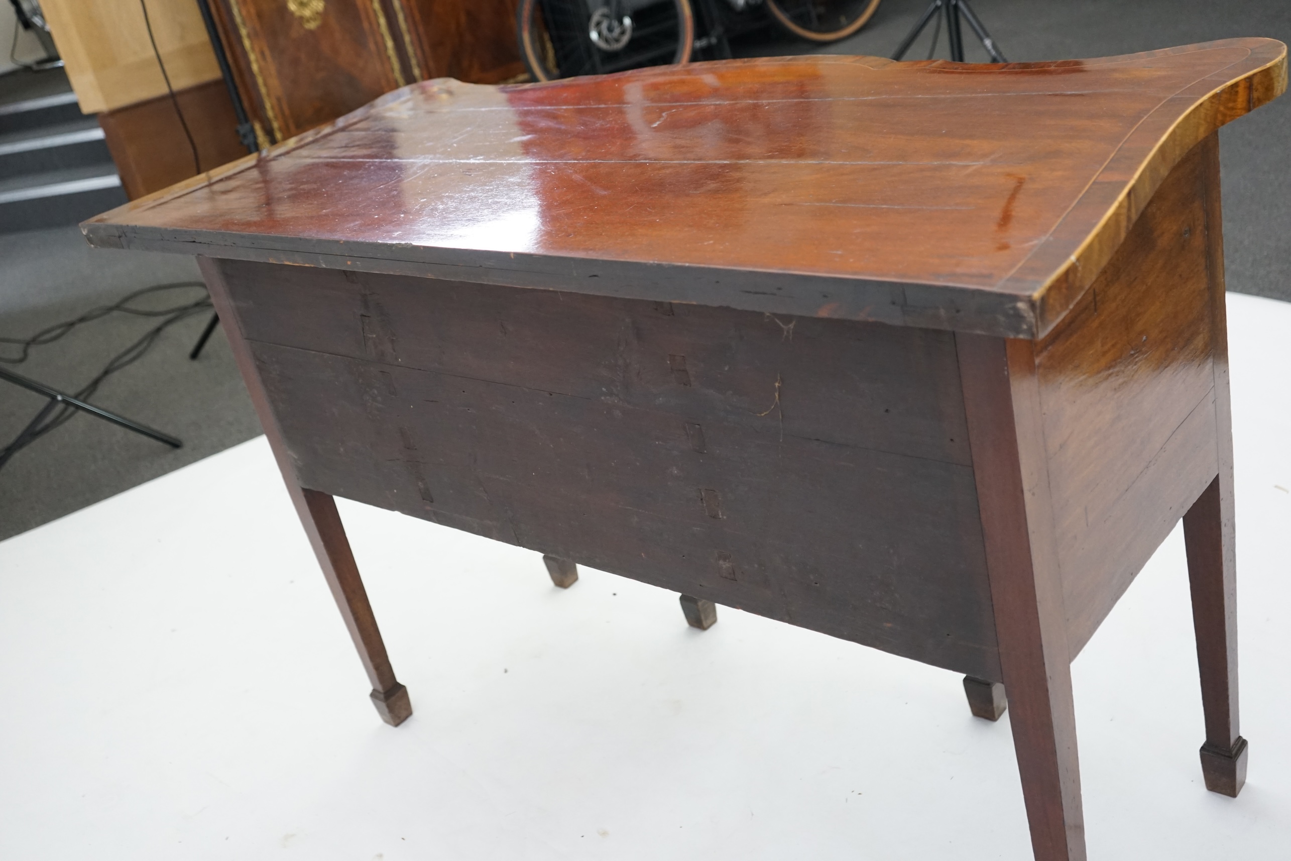 A George III inlaid mahogany serpentine sideboard